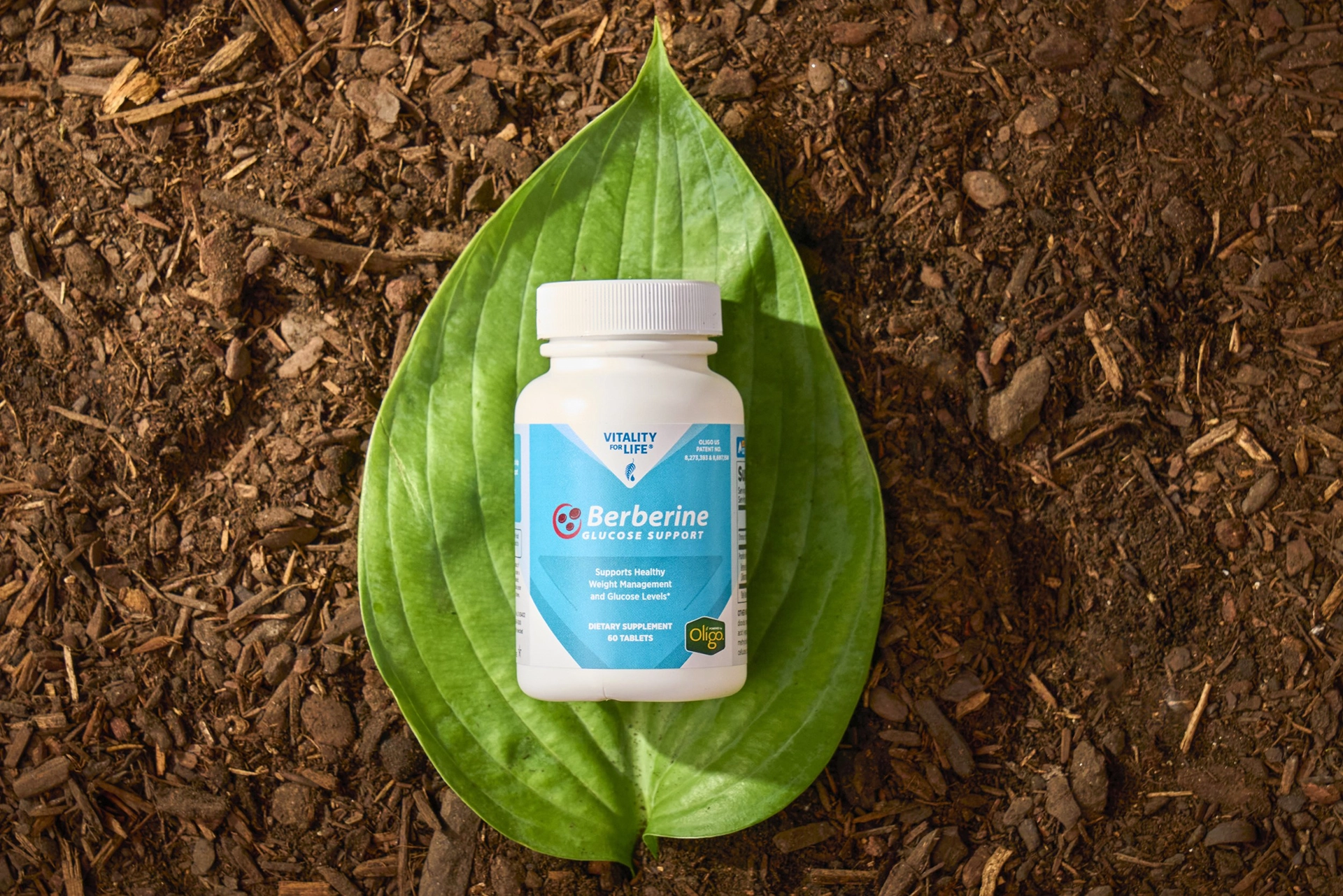 A bottle of Melaleuca Berberine Glucose Support on a leaf.